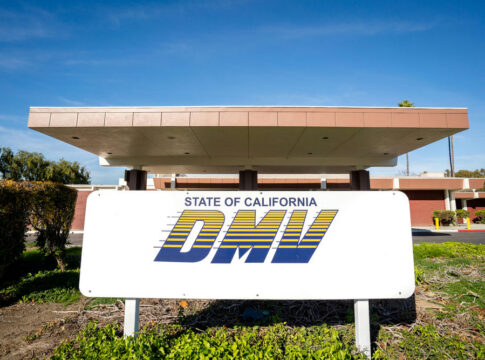 California DMV building with sign and greenery