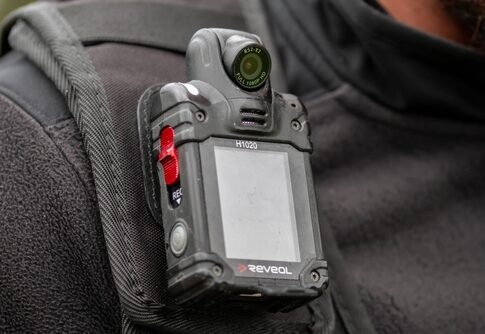 Close-up of a body camera attached to a persons shoulder