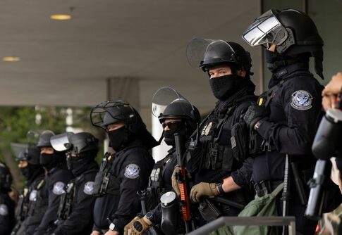Group of police officers in riot gear standing in formation